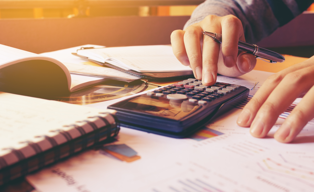 Woman,Using,Calculator,With,Doing,Finance,At,Home,Office.